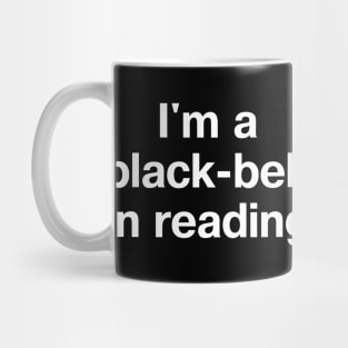 "I'm a black-belt in reading" in plain white letters - bibliophiles of the world, unite (in the library) Mug